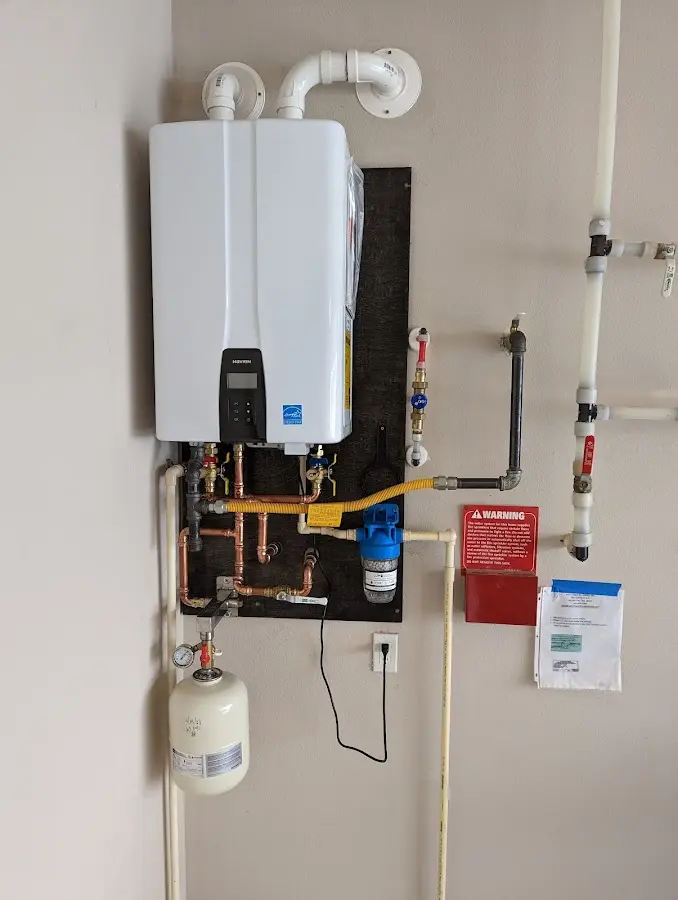 Professional plumber installing copper piping in a Kosciusko home